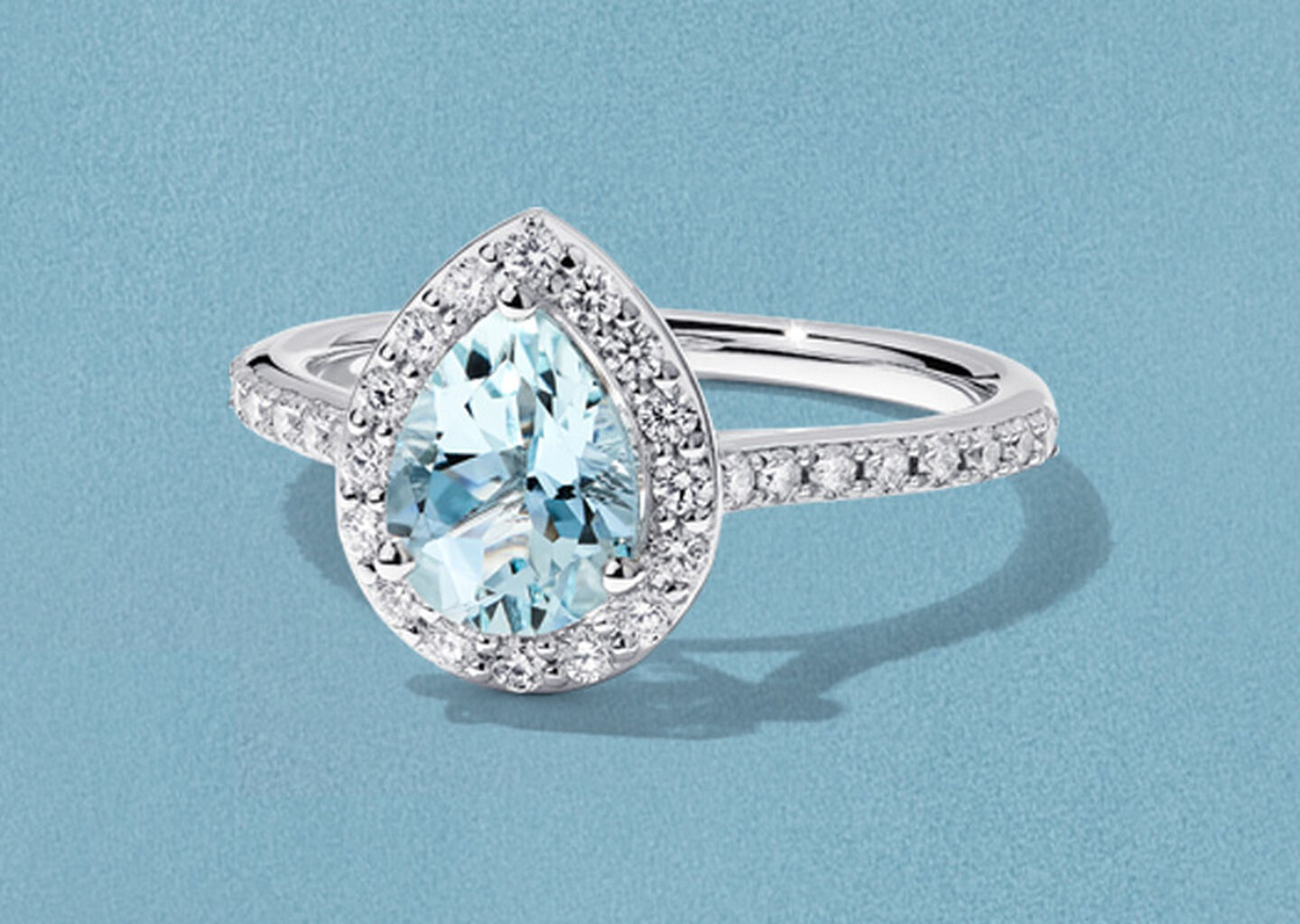 Birks Rosee du Matin aquamarine and diamond ring on a blue background.