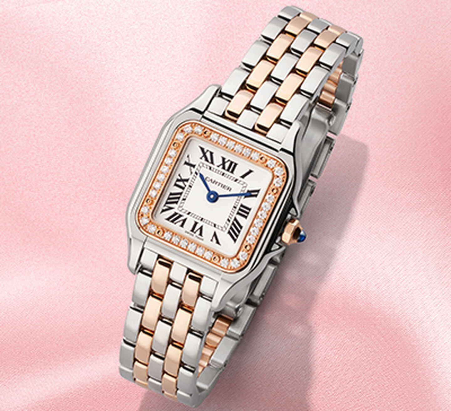 Cartier Panthere two tone rose gold and stainless steel watch on a pink background
