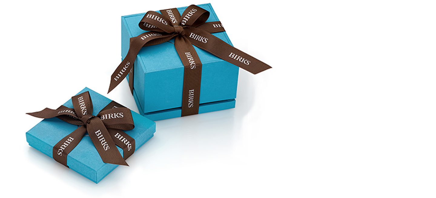 Maison Birks Signature Blue Box wrapped in brown ribbon.