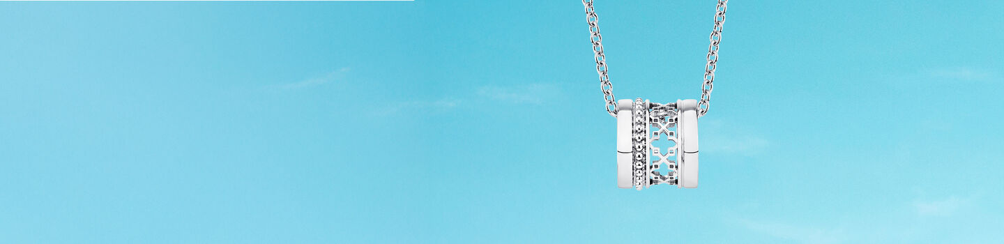 Birks Dare to Dream silver pendant on a blue background.