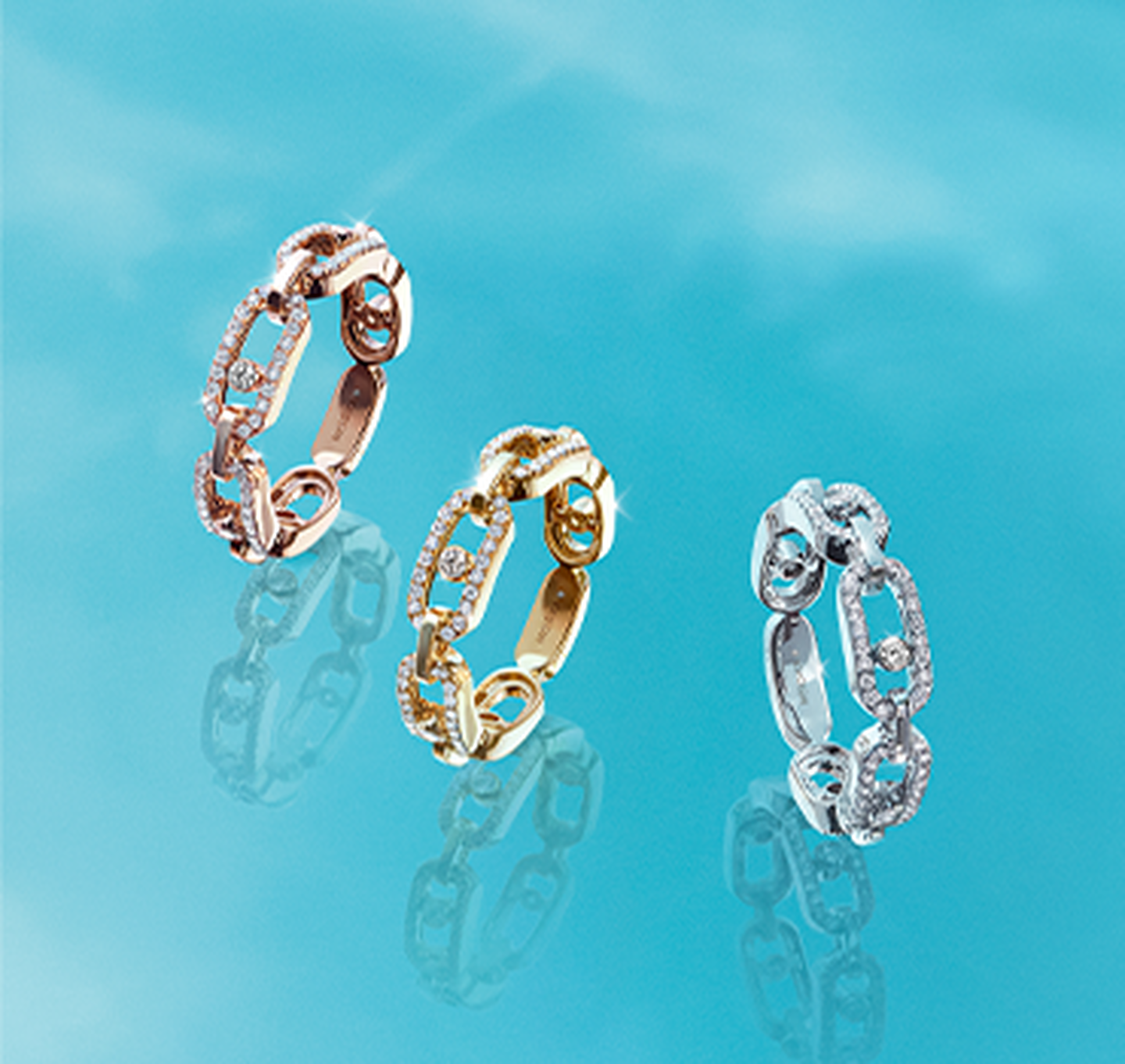 Three floating rose, white, and yellow gold Messika rings. 