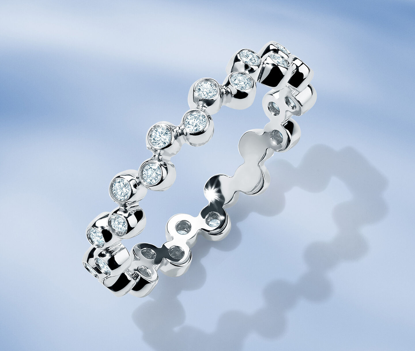 Birks Iconic Splash diamond ring on a blue background.