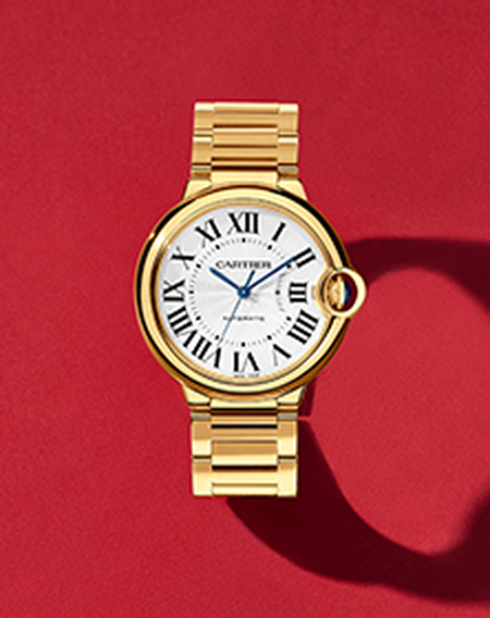 Cartier Ballon Bleu watch on a red background.