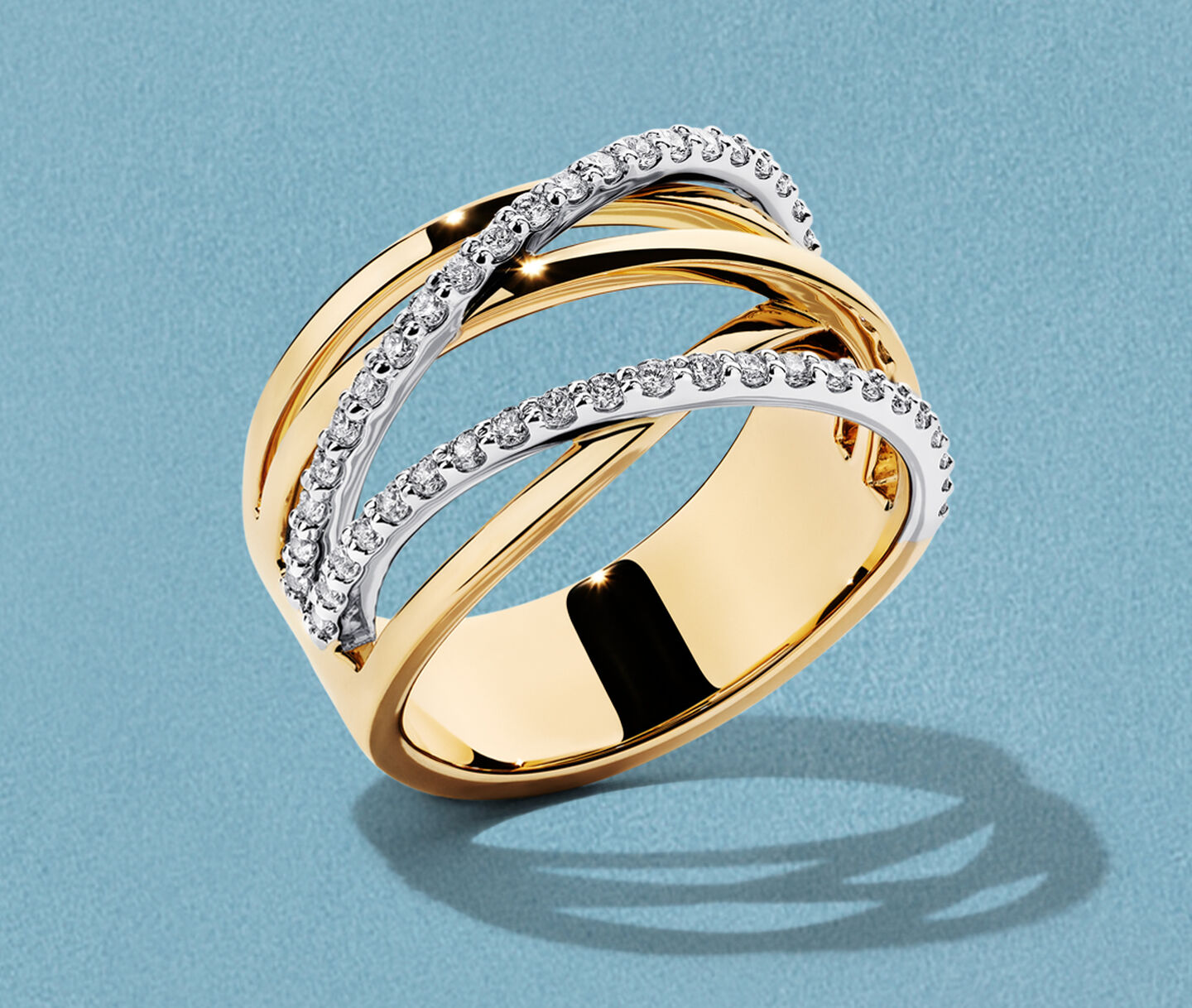 Birks Rosee du Matin yellow gold ring on a blue background.