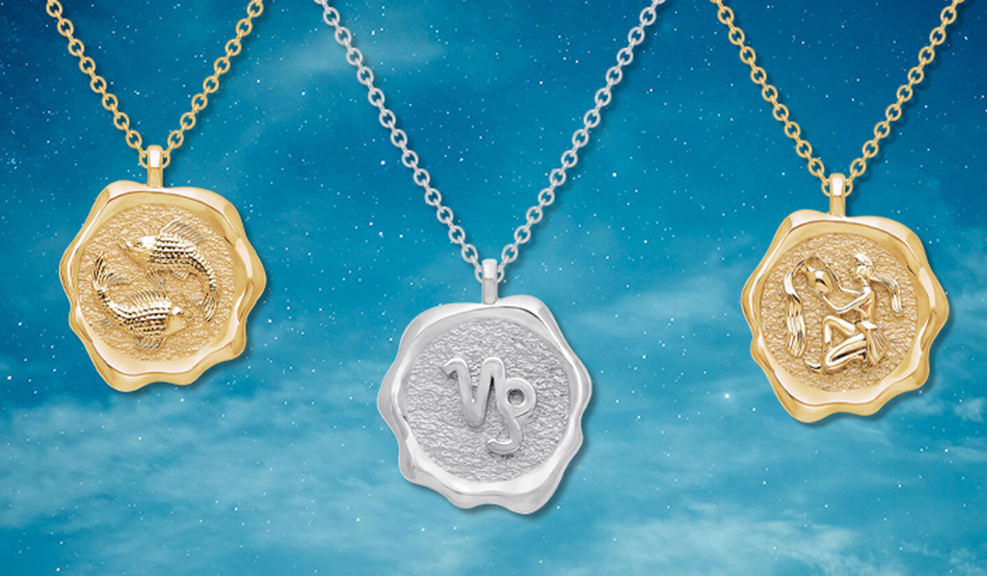 Birks Essentials gold Pisces, silver Capricorn, and gold Aquarius pendants on a sky background.