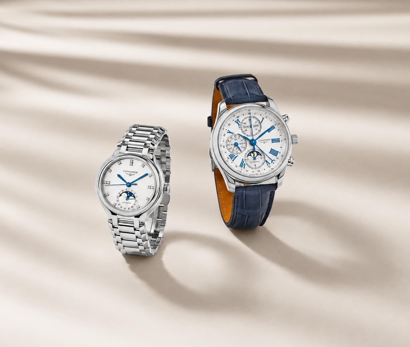 Longines moonphase watches on a beige satin background.