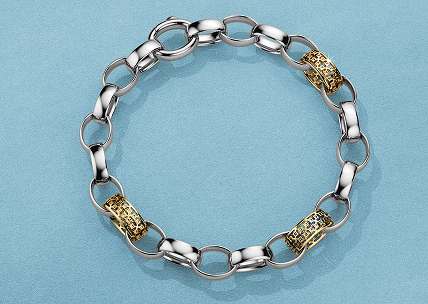Birks Dare to Dream silver and gold bracelet on a blue background.