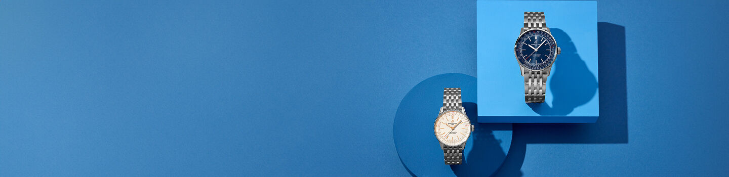 Breitling Navitimer watches on a blue background.