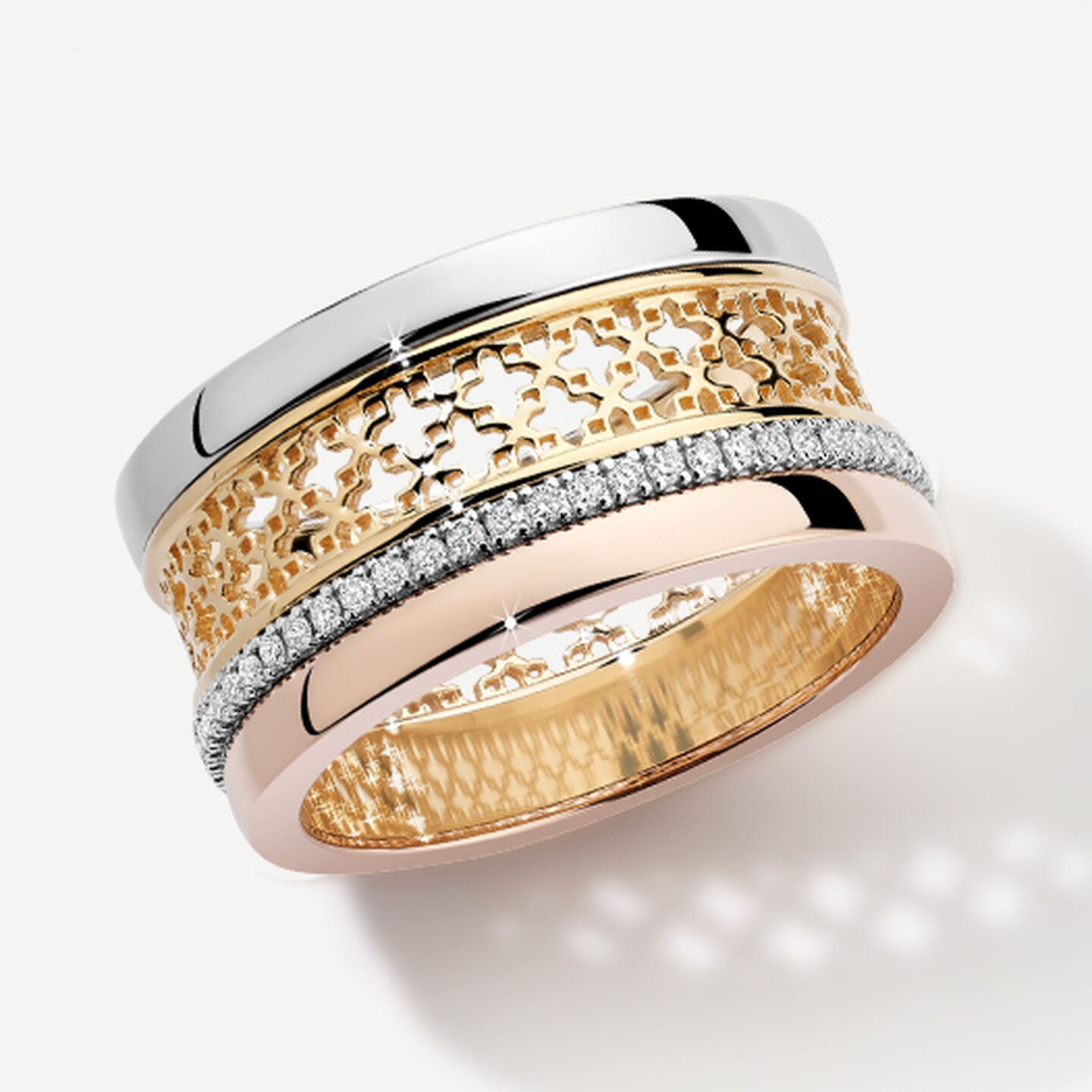 Birks Dare to Dream tri-gold ring on a grey background.