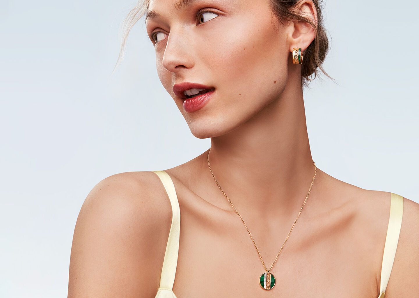 A woman wearing Birks Dare to Dream malachite jewellery.