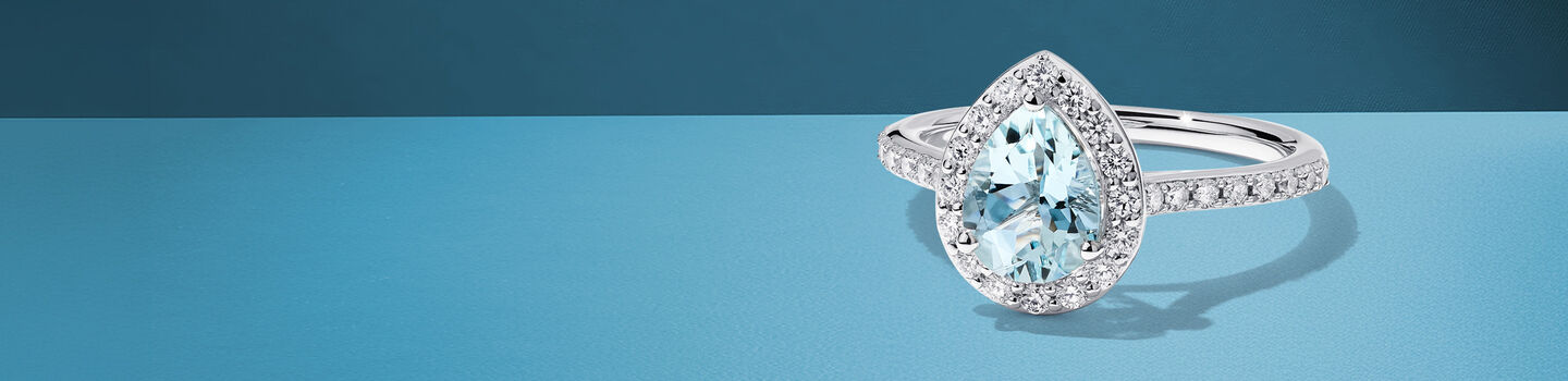 Birks Rosee du Matin aquamarine engagement ring on a blue background.