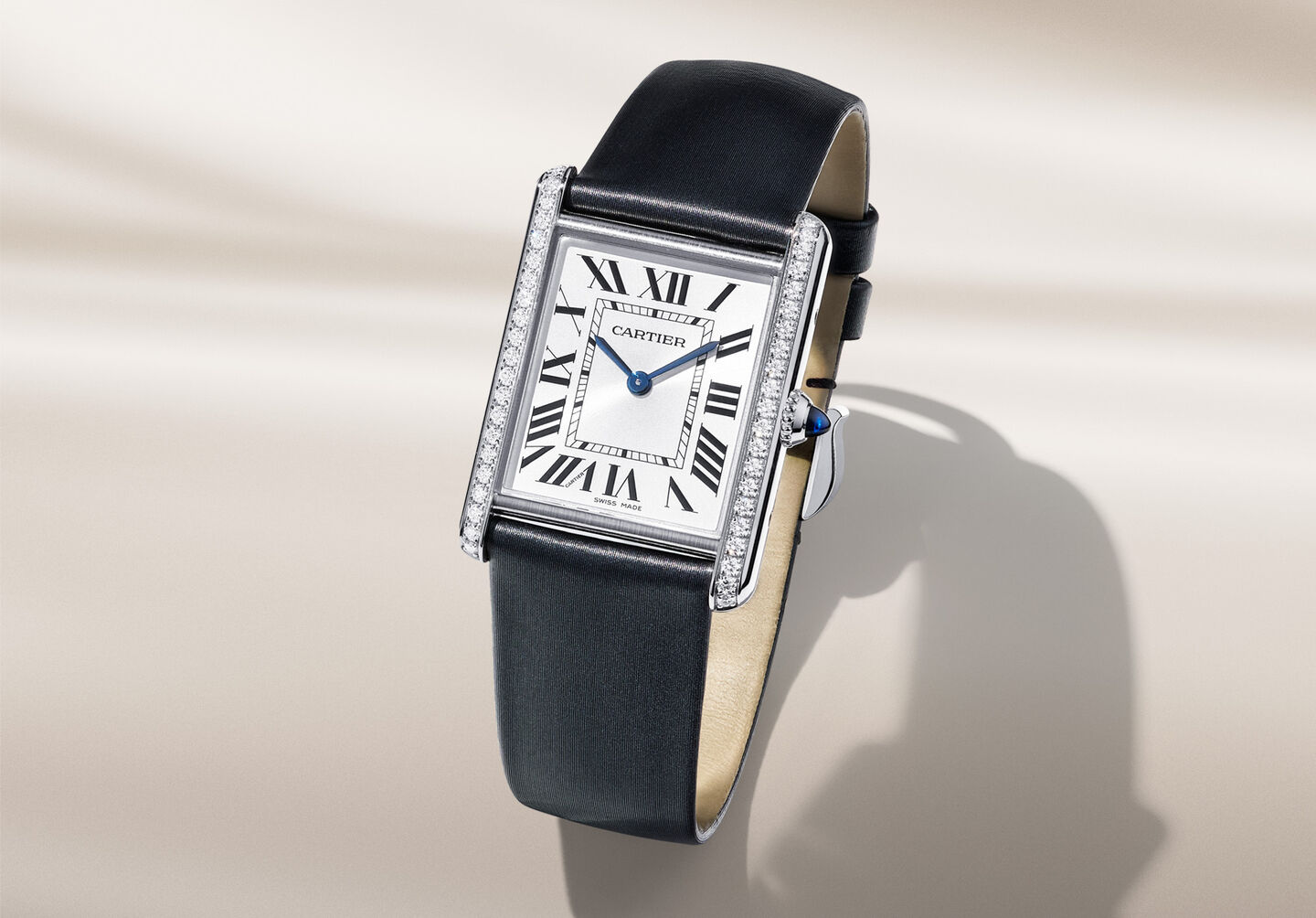 Tank Must de Cartier watch on a beige background