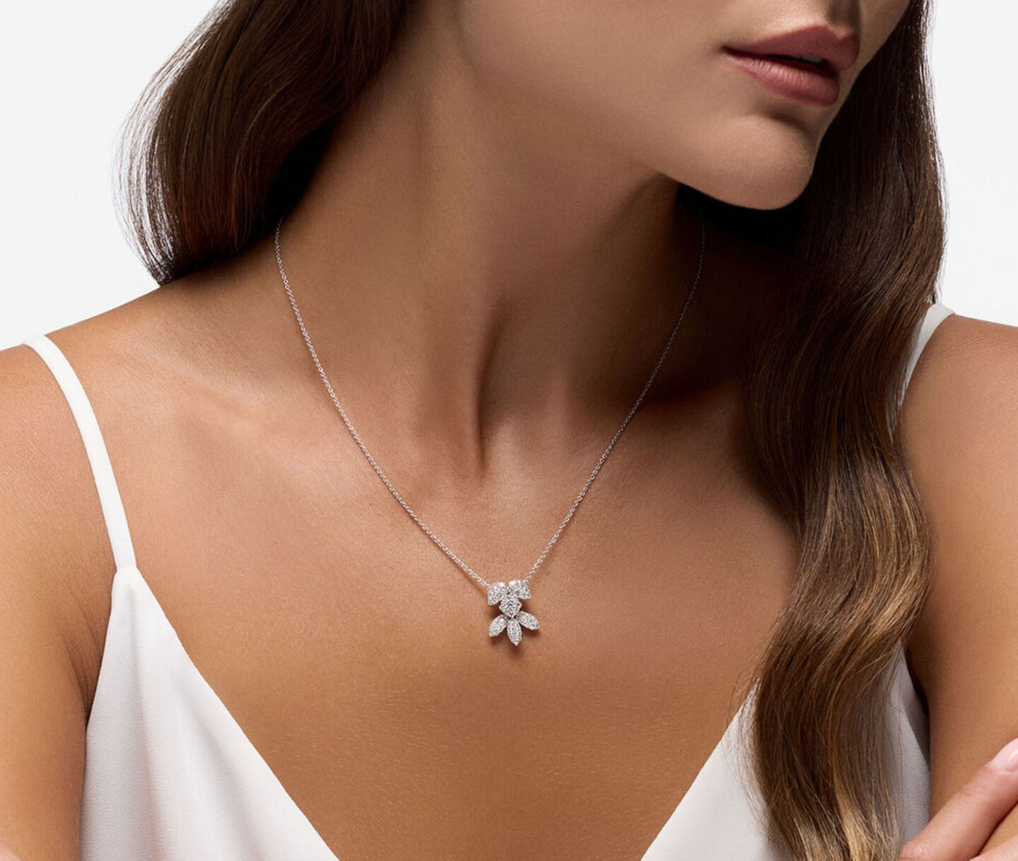 A woman wearing the Birks Snowflake diamond necklace.