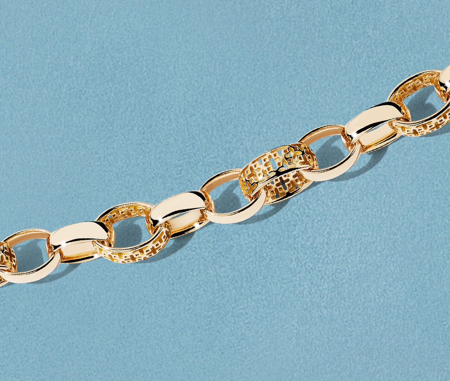 Birks Dare to Dream gold chain necklace on a blue background.