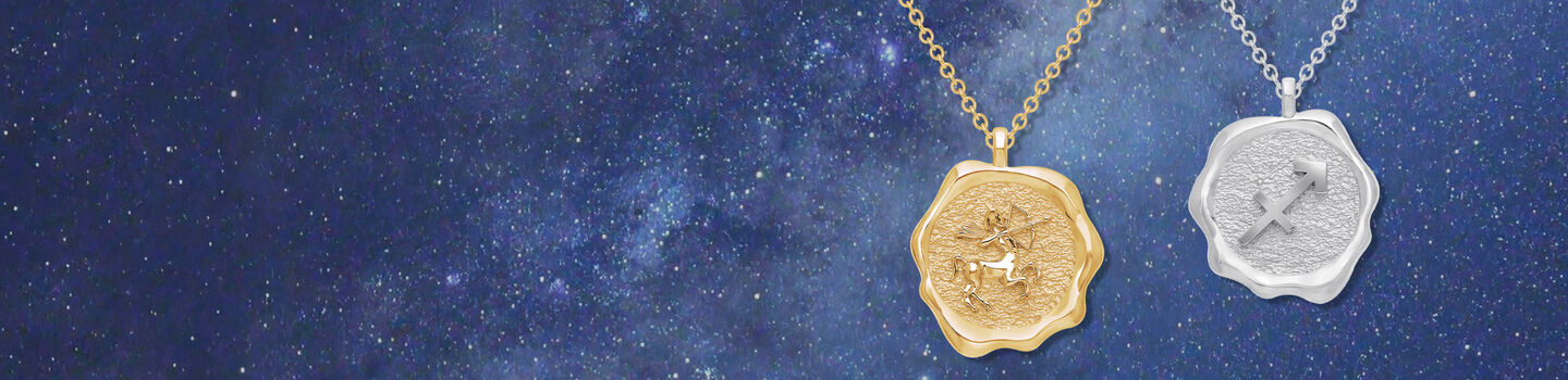 Birks Essentials Zodiac Sagittarius pendants in yellow gold and silver on a starry background.
