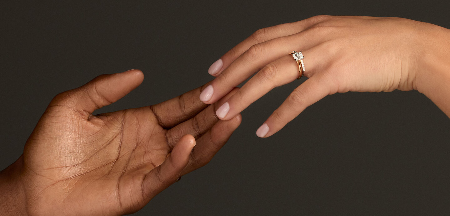 Un couple s&rsquo;enla&ccedil;ant le jour de son mariage, portant des bijoux Birks. 