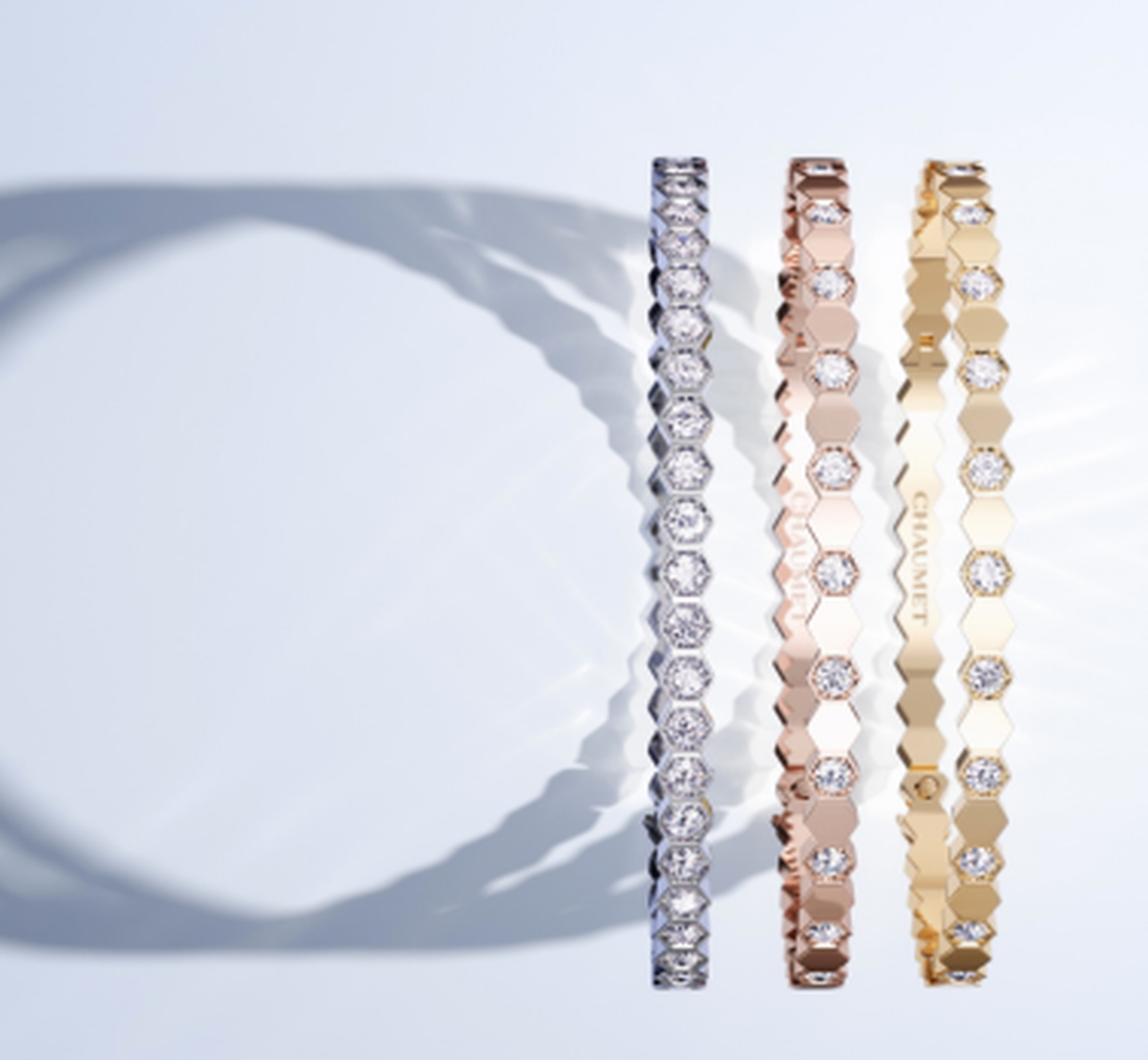 Chaumet Bee My Love bracelets on a white grey background.