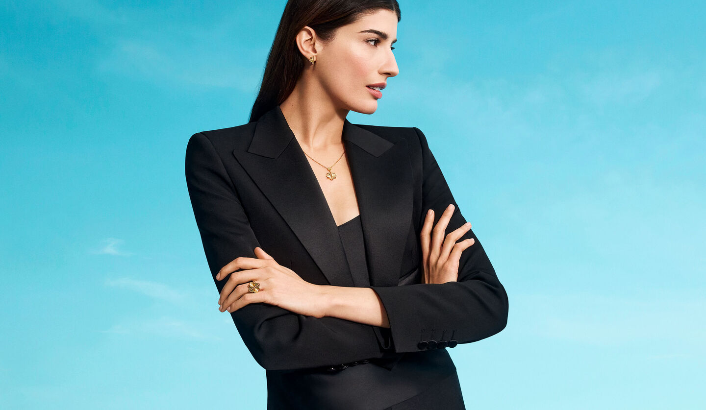 A woman wearing Birks Muse yellow gold jewellery.