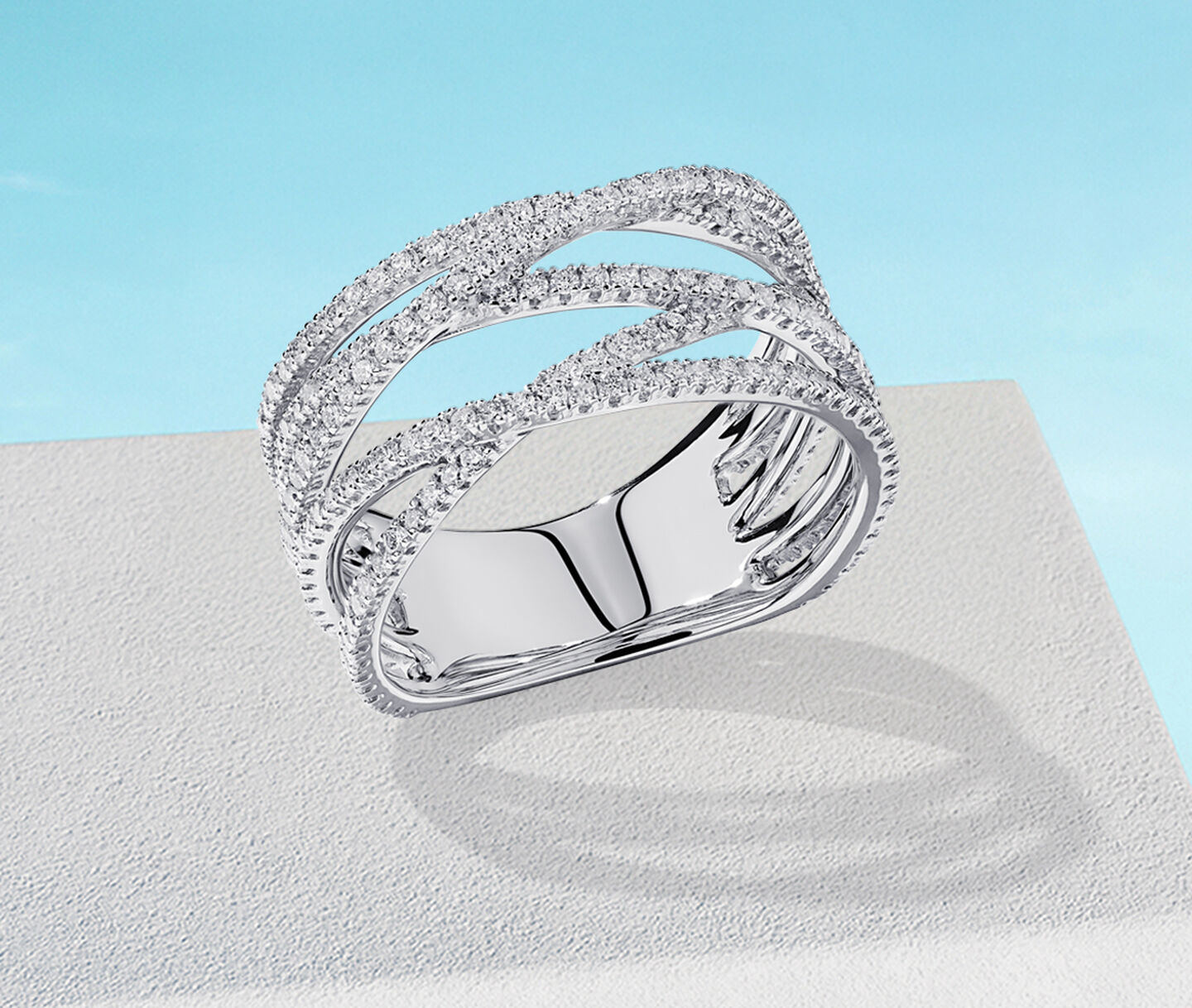 Birks Rosee du Matin white gold ring on a blue background.