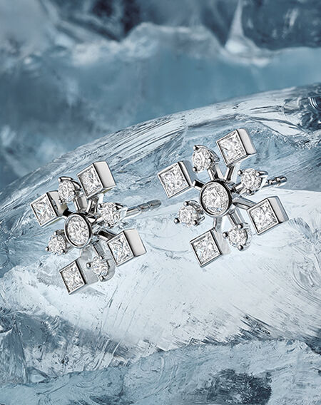 Birks Snowflake diamond earrings on a ice blue background