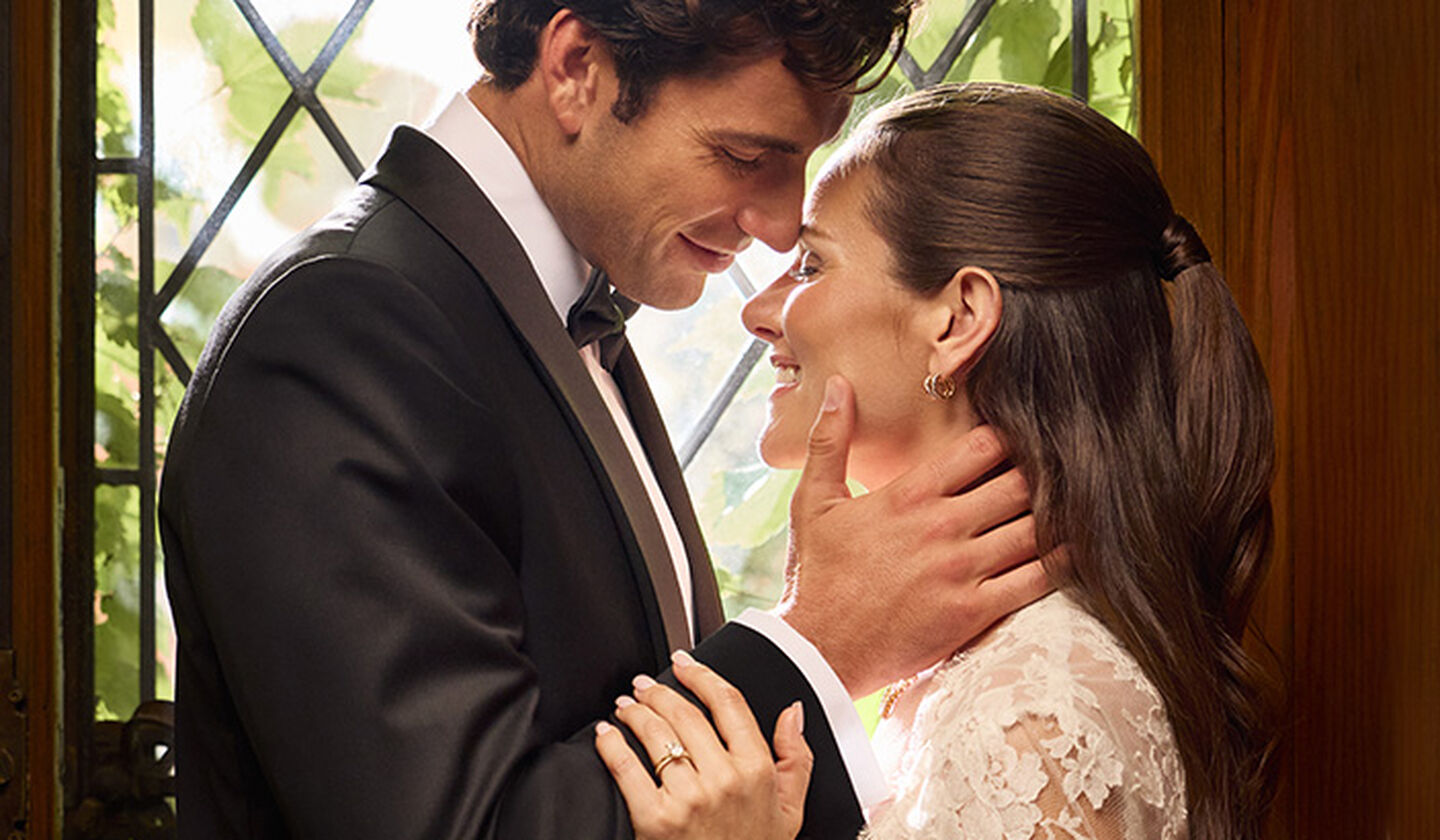 A closeup of a couple wearing Birks Bridal jewellery.