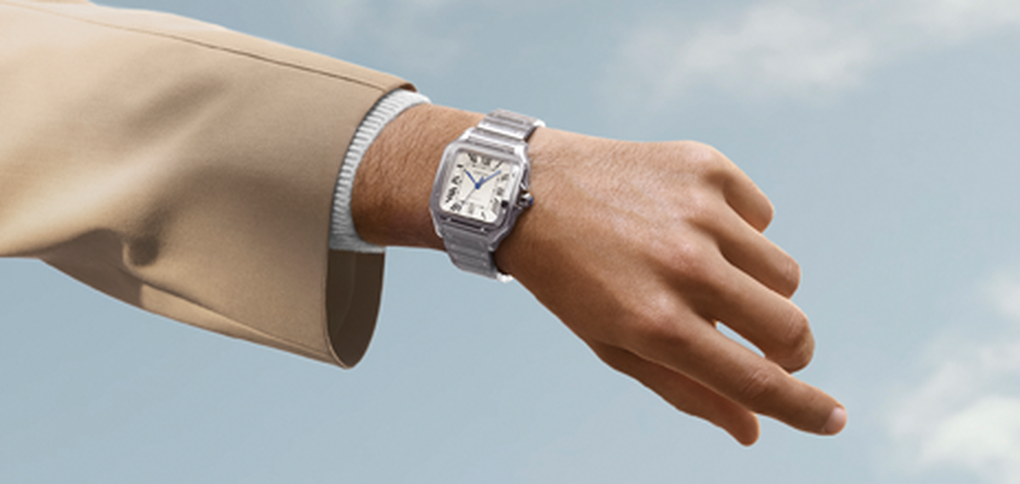 A wrist wearing a Cartier watch.