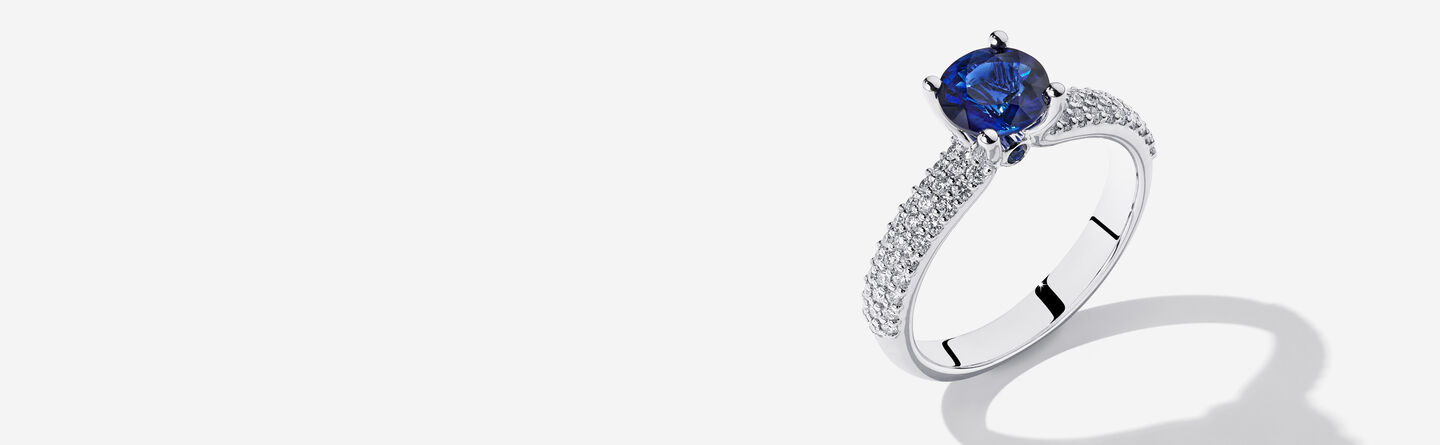 A couple embracing with a Birks engagement ring.
