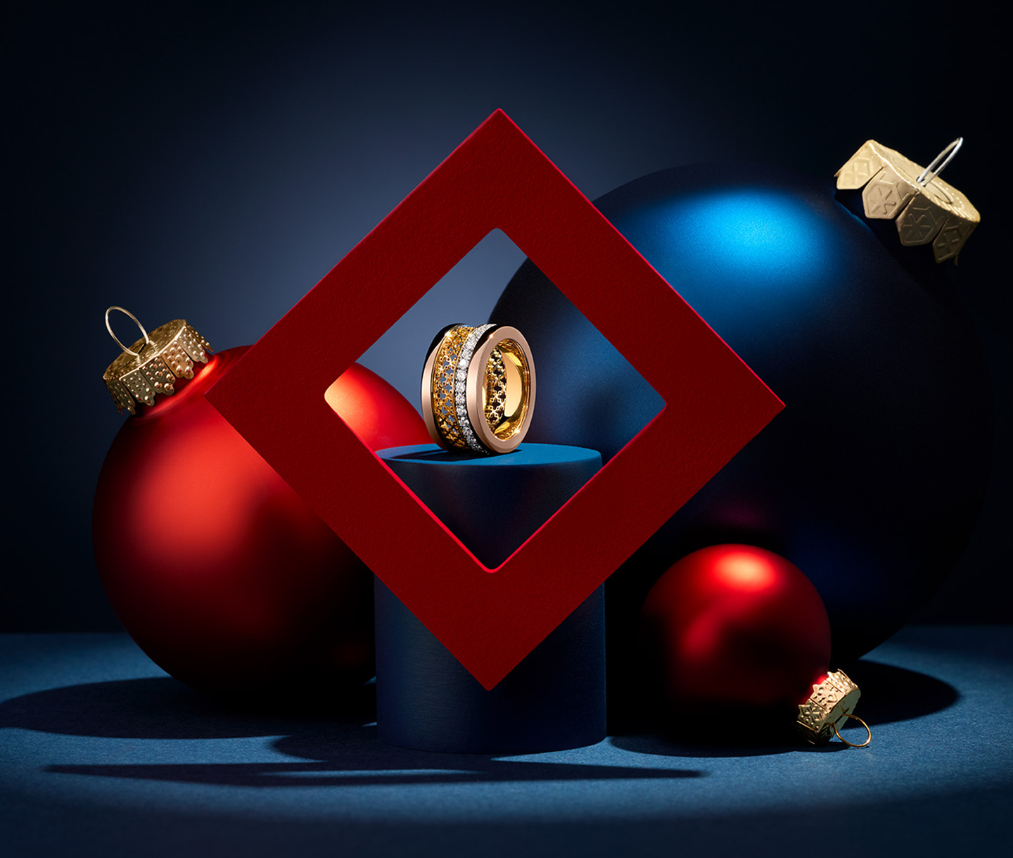 A Birks Dare to Dream tri-gold ring on a holiday background.