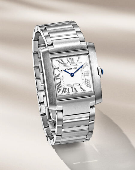 Tank de Cartier watches on a beige background.