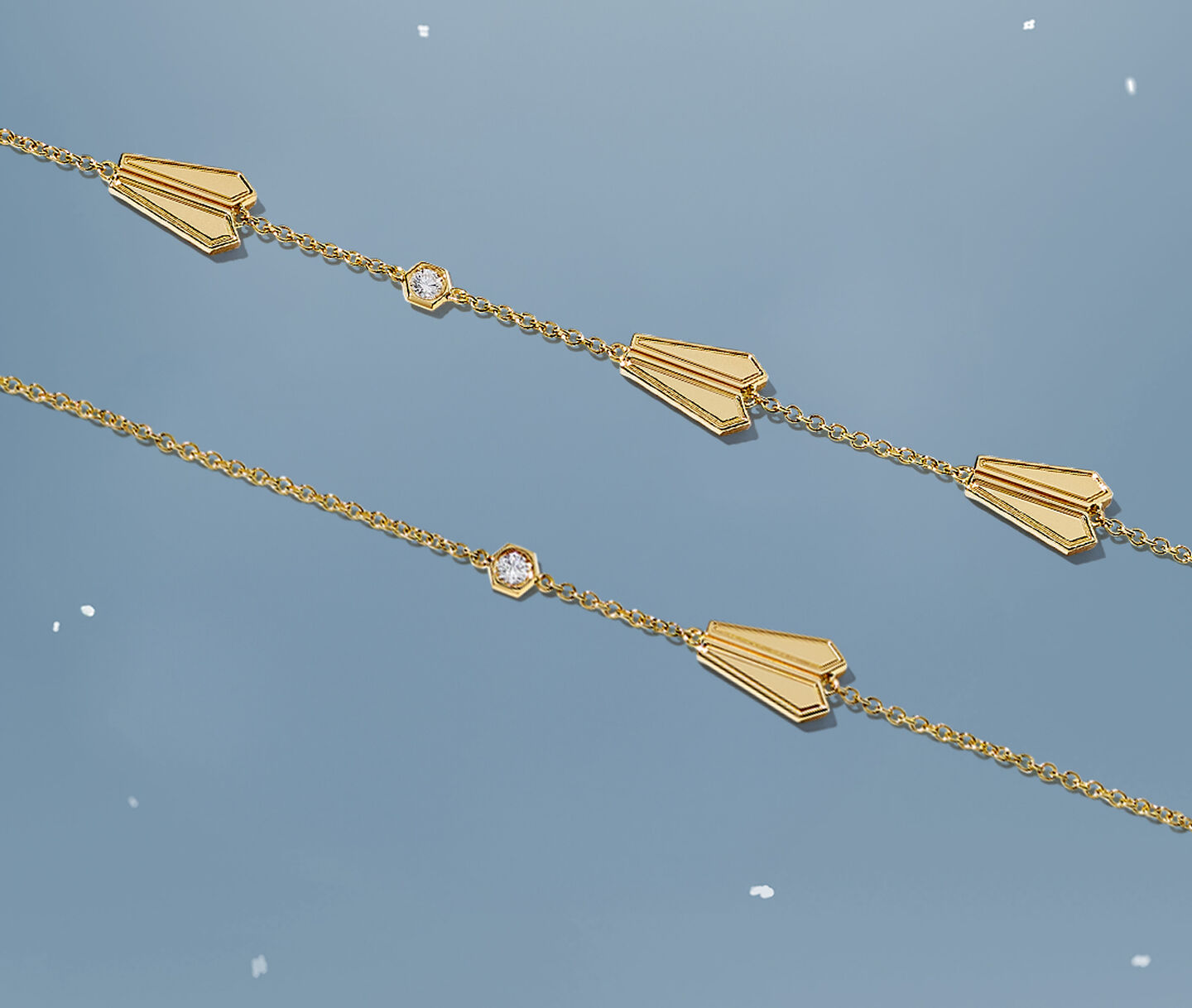 Birks Dare to Dream tri-gold ring on a sky background.