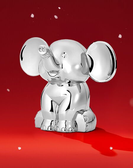 Birks elephant coin back on a red background.