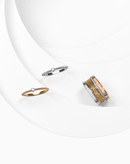 Birks Dare to Dream tri-gold diamond ring and Marco Bicego Bi49 yellow and white gold rings.