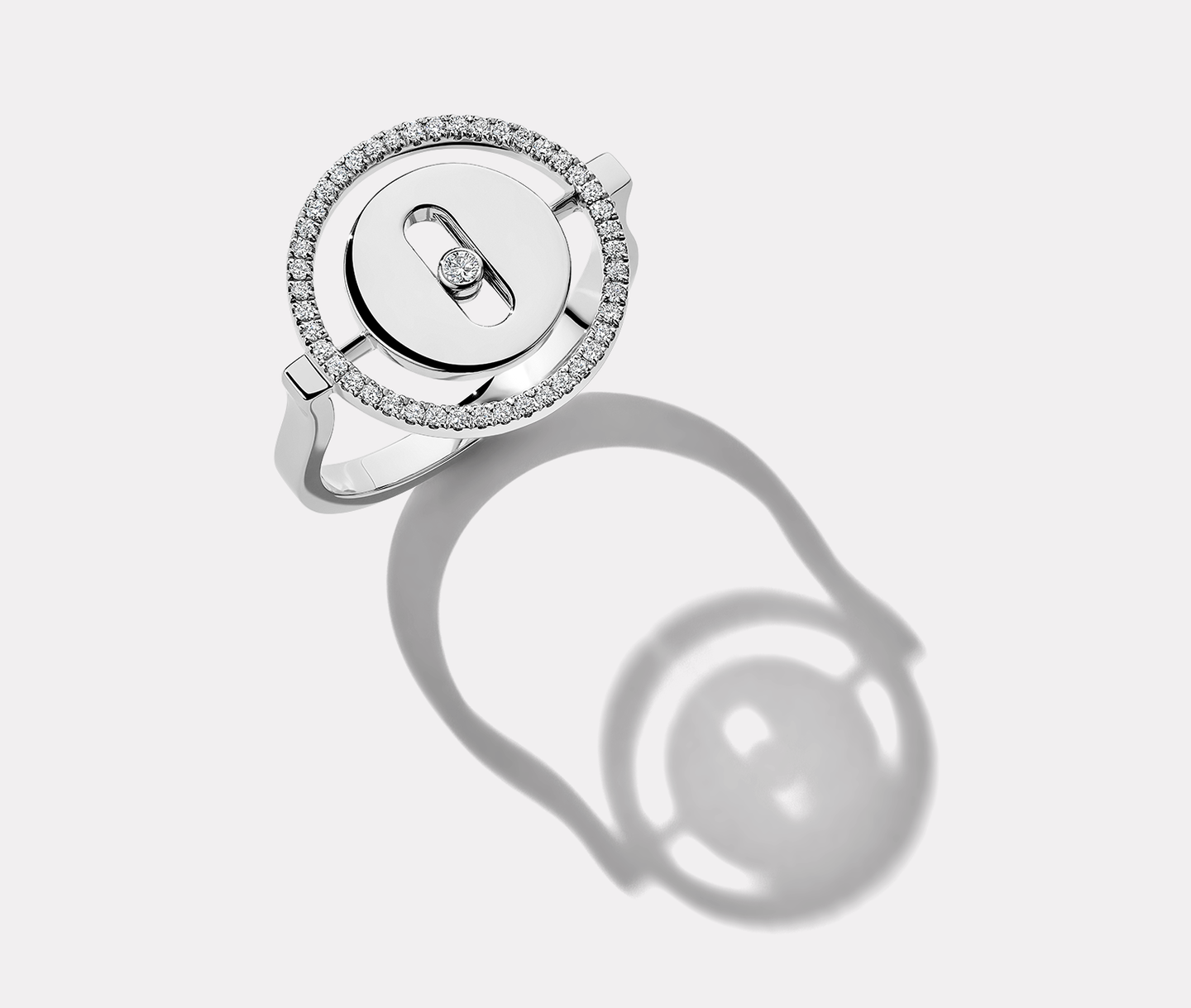 Messika diamond move ring on a pearl white background.,