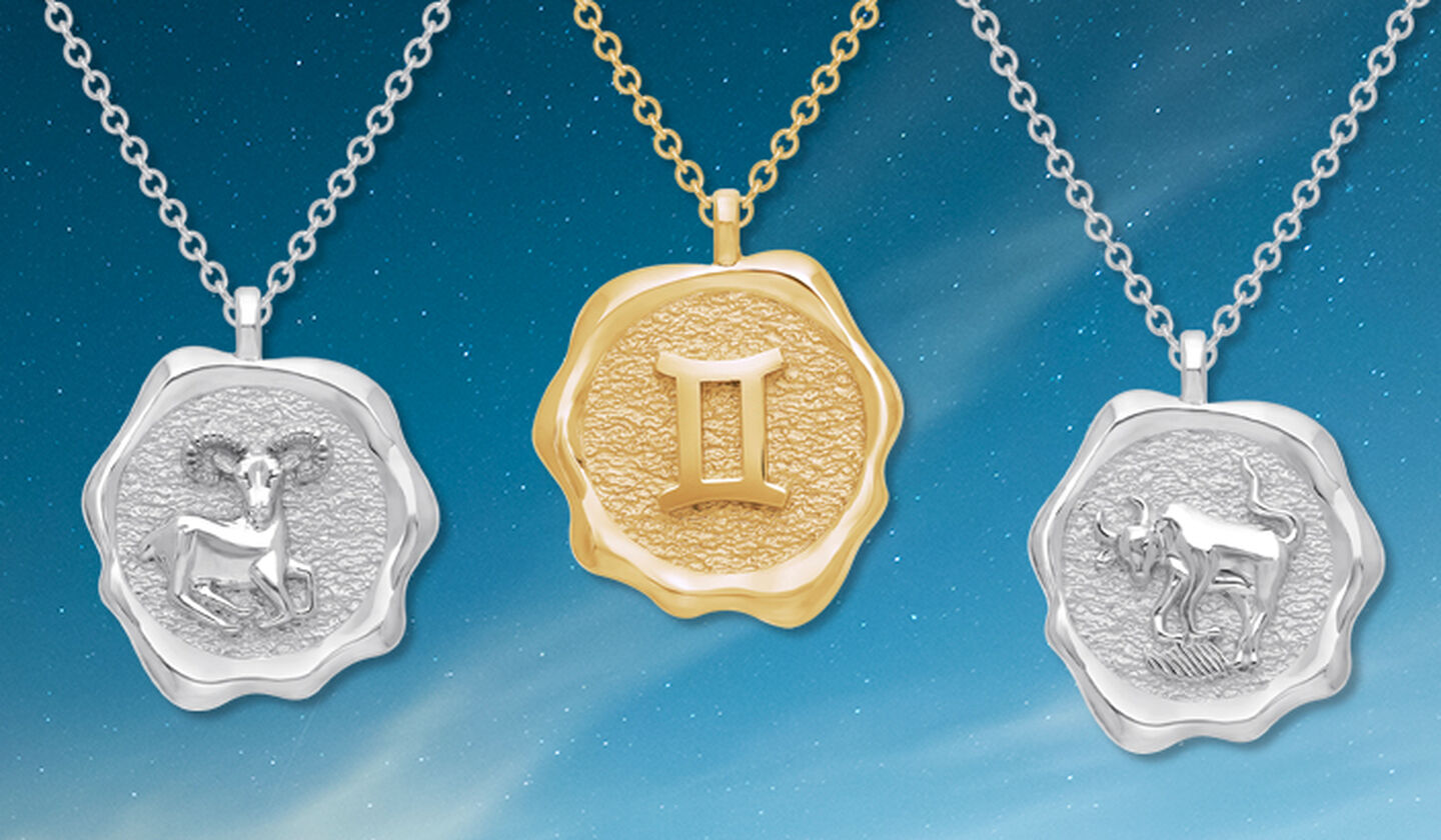 Birks Essentials gold Gemini, silver Aries, and silver Taurus pendants on a sky background.