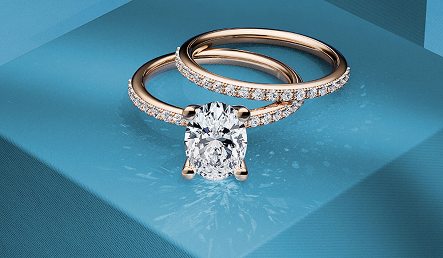 A Birks Rosee Du Matin diamond engagement and rose gold diamond Ring on a blue background.