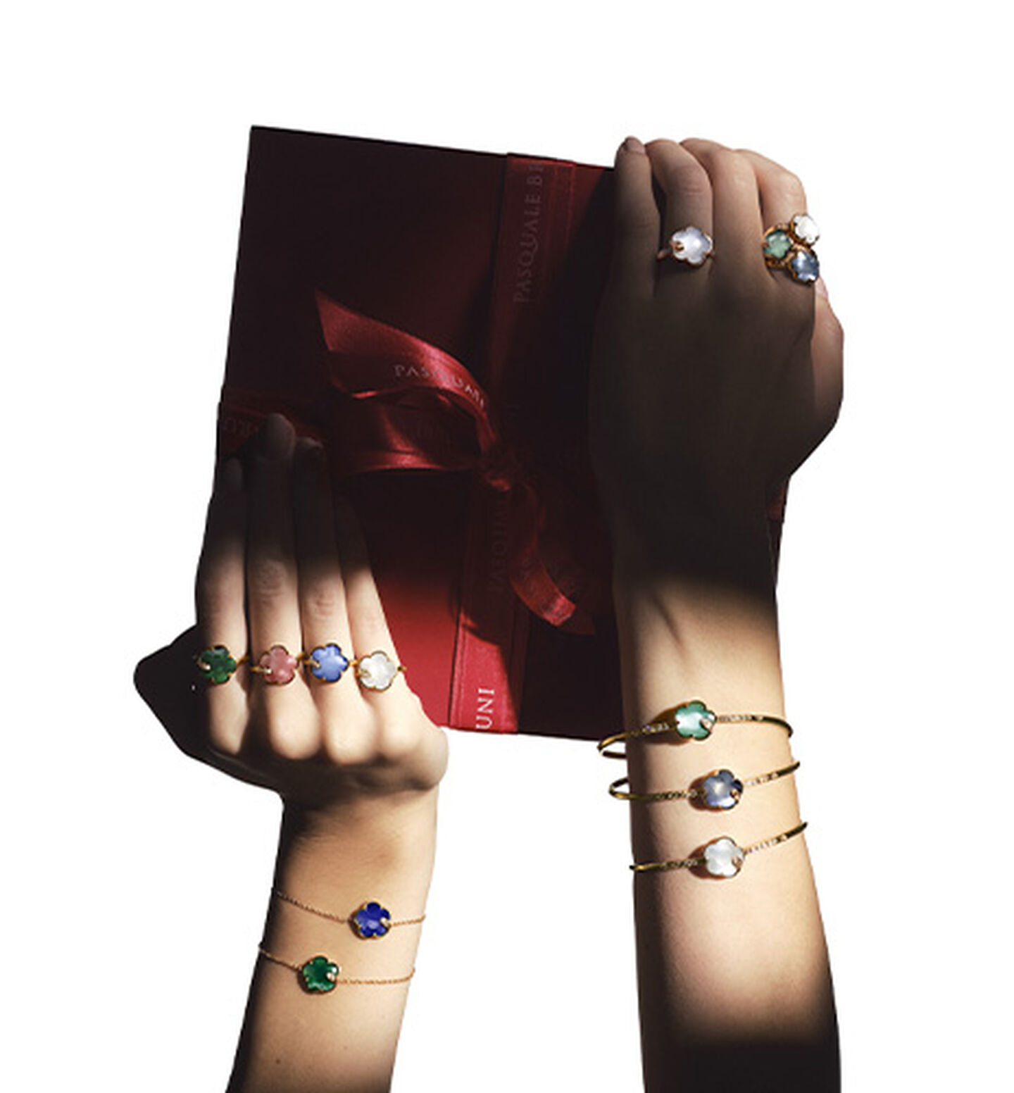 A woman holding a gift box wearing Pasquale Bruni Petit Joli jewellery.