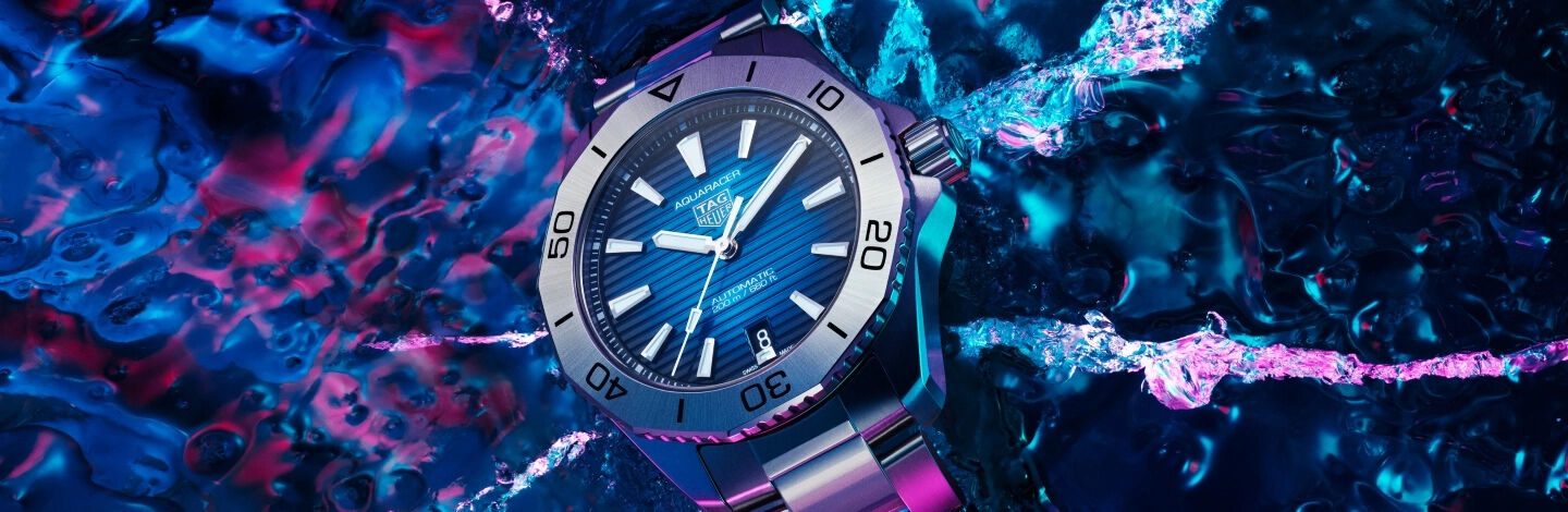 TAG Heuer watch over a blue and pink water reflection
