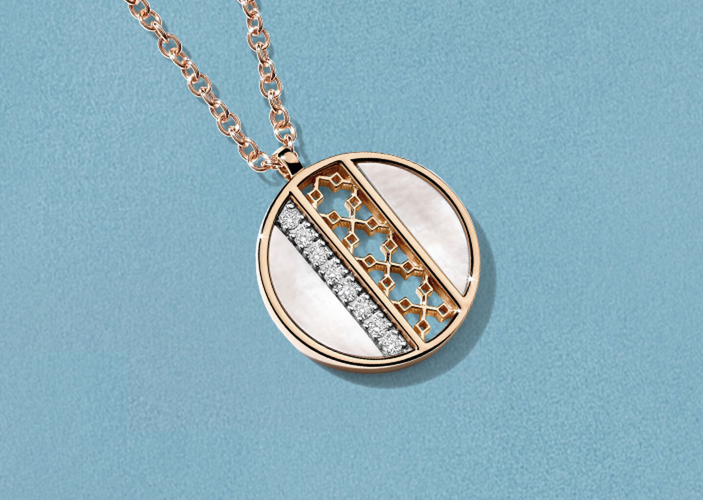 Birks Dare to Dream mother-of-pearl pendant on a blue background.