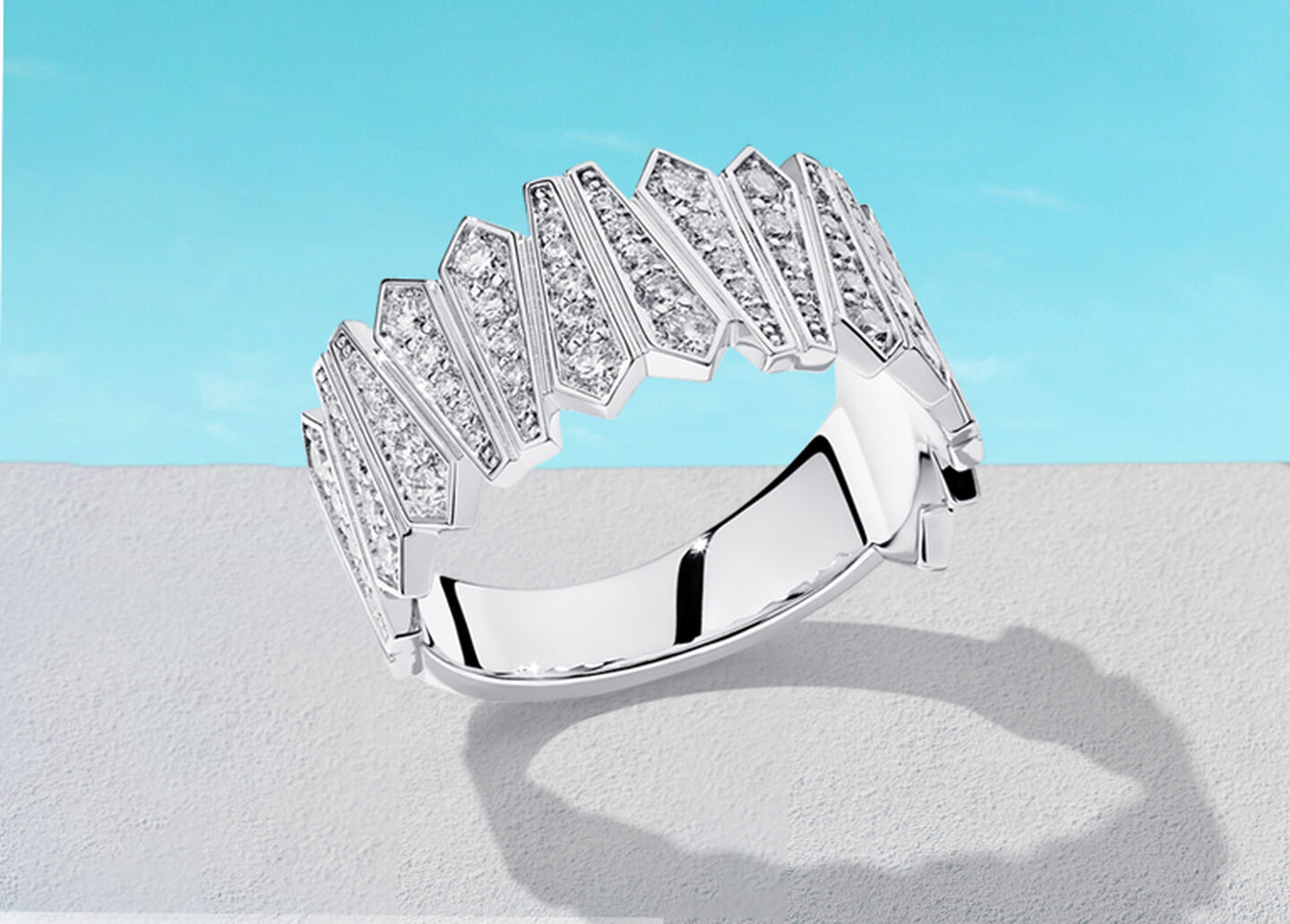 Birks Beekeeper white gold and diamond ring on a blue background.