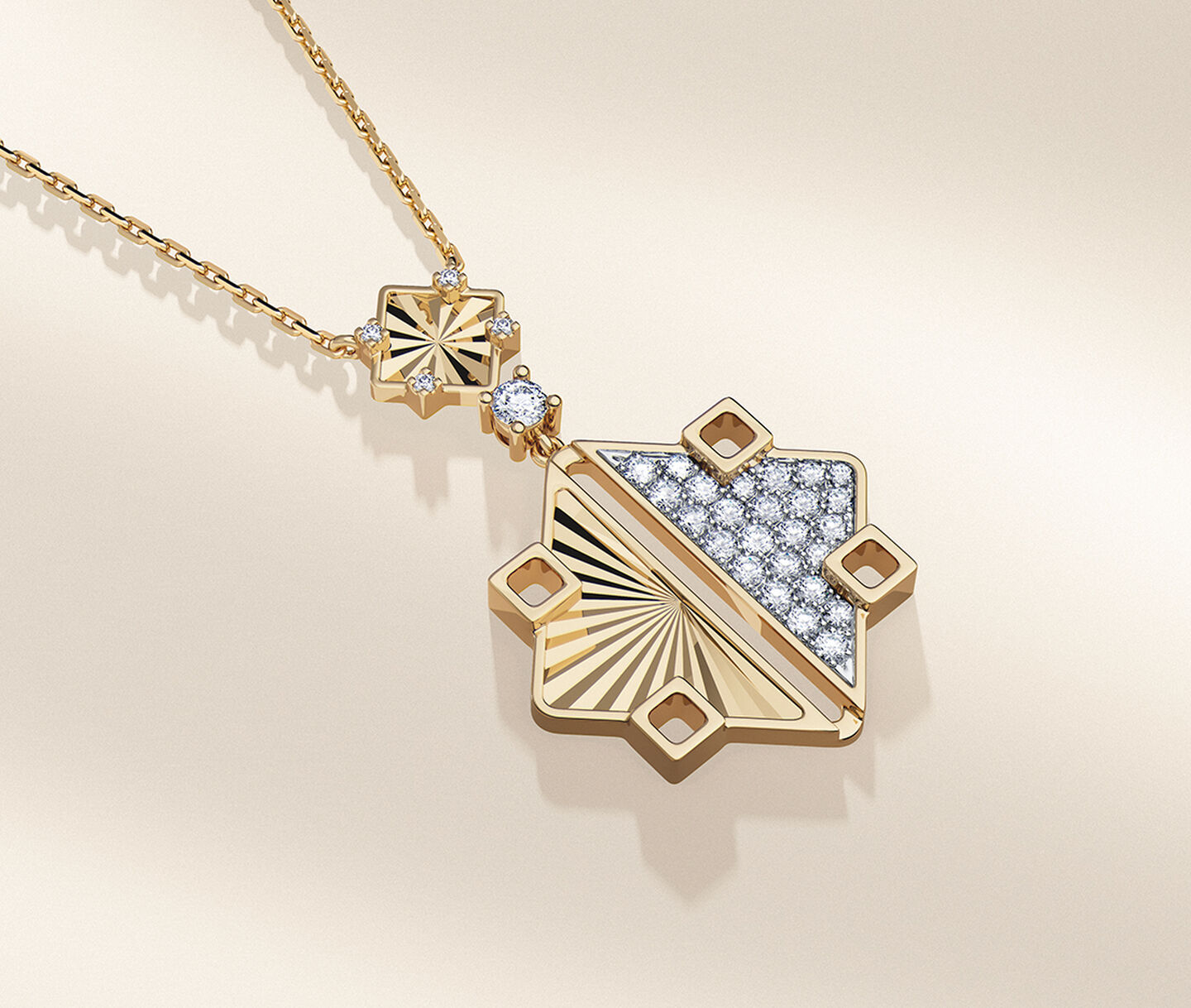 Birks Muse yellow gold and diamond drop pendant on a beige background.