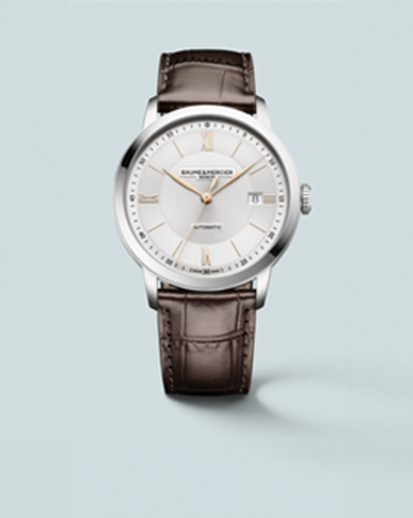 Baume & Mercier Classima watch on a light blue background.