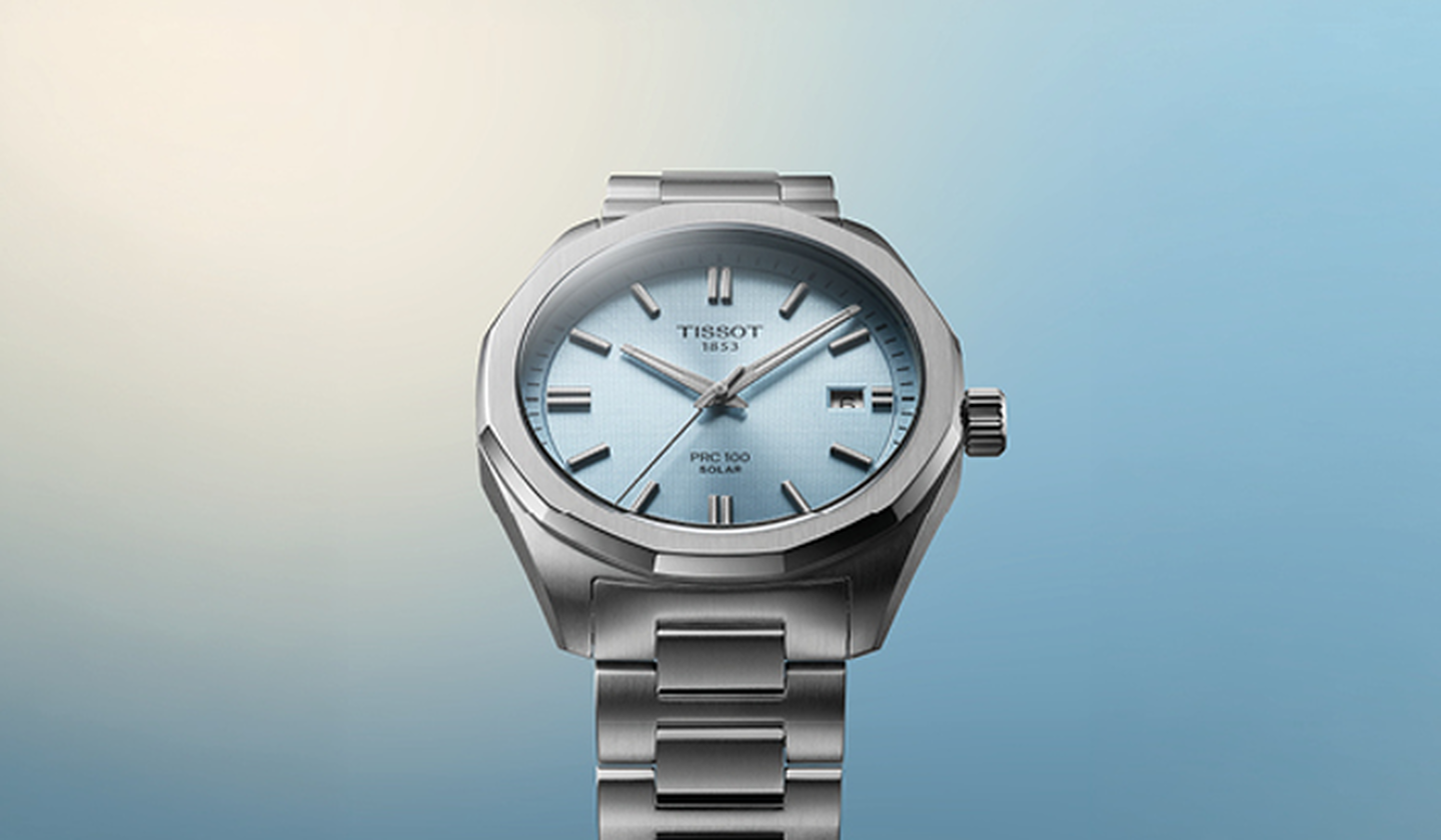 Tissot watch on a blue background.