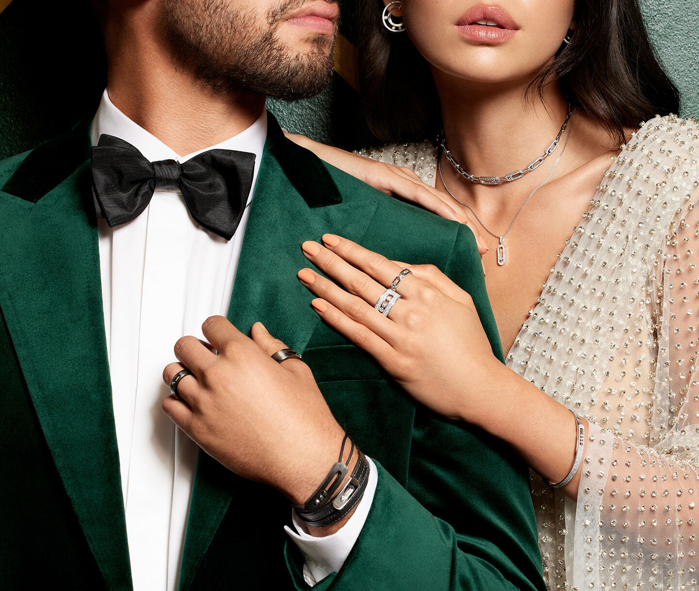 A man and woman dressed for the holiday season in Messika jewellery.