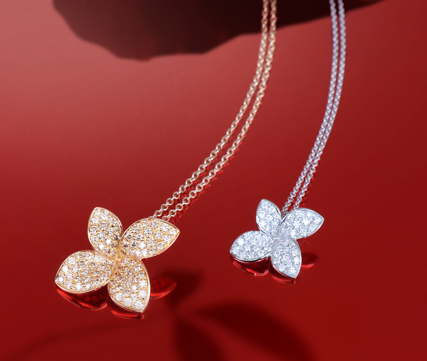 Two Pasquale Bruni Petit Garden necklaces on a red background