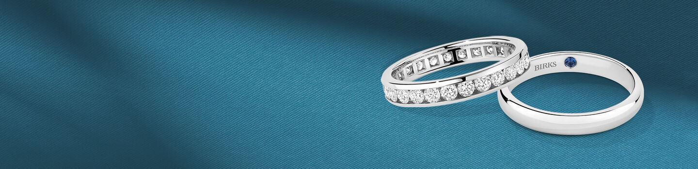White gold wedding band and diamond ring with blue accent stone