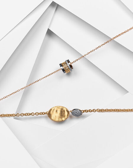 Bracelet en trois ors et diamant de Birks Dare to Dream avec un bracelet Lunaria de Marco Bicego en or jaune et diamants sur un fond blanc