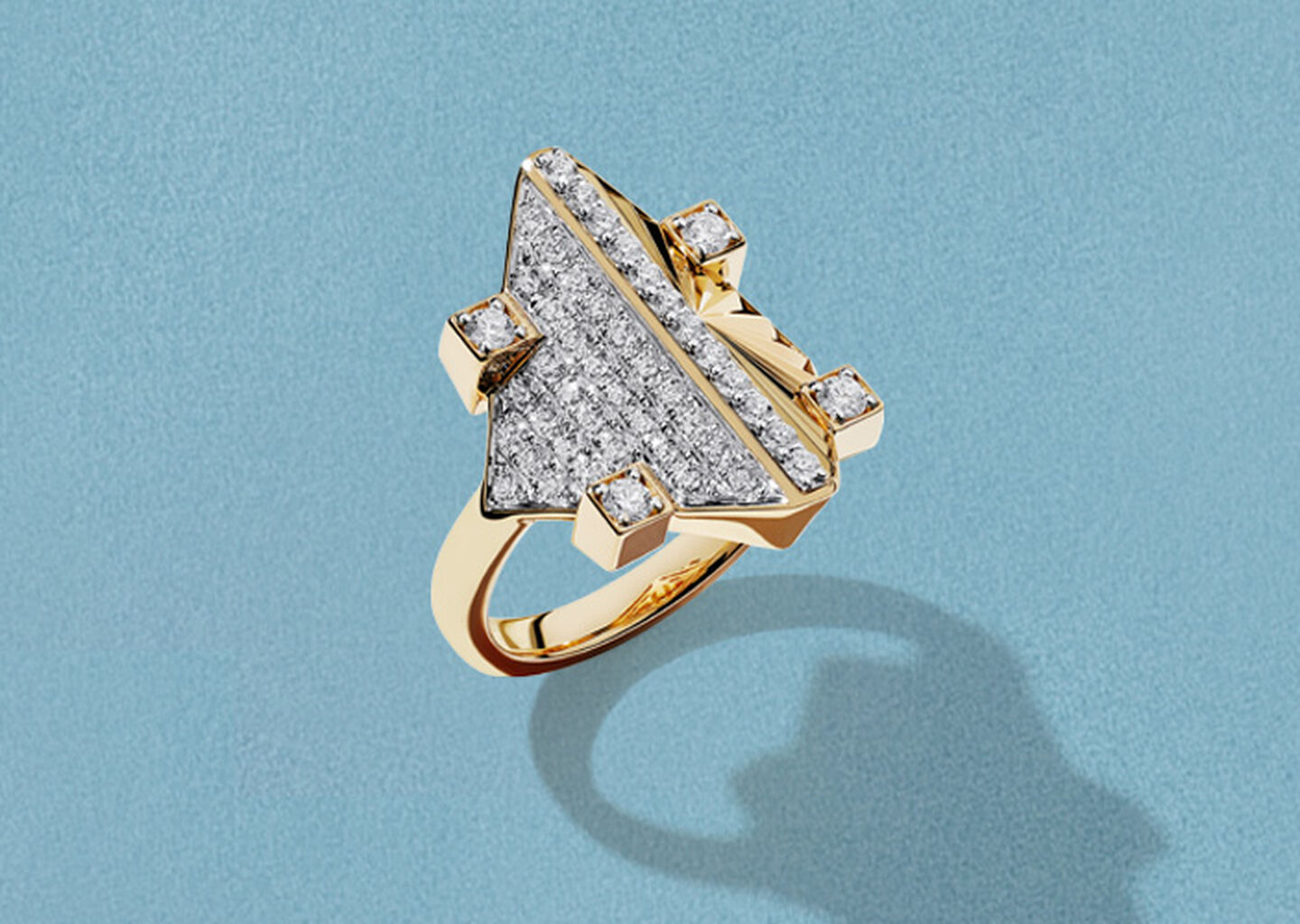  Birks Muse Exceptional yellow gold and diamond ring on a blue background.