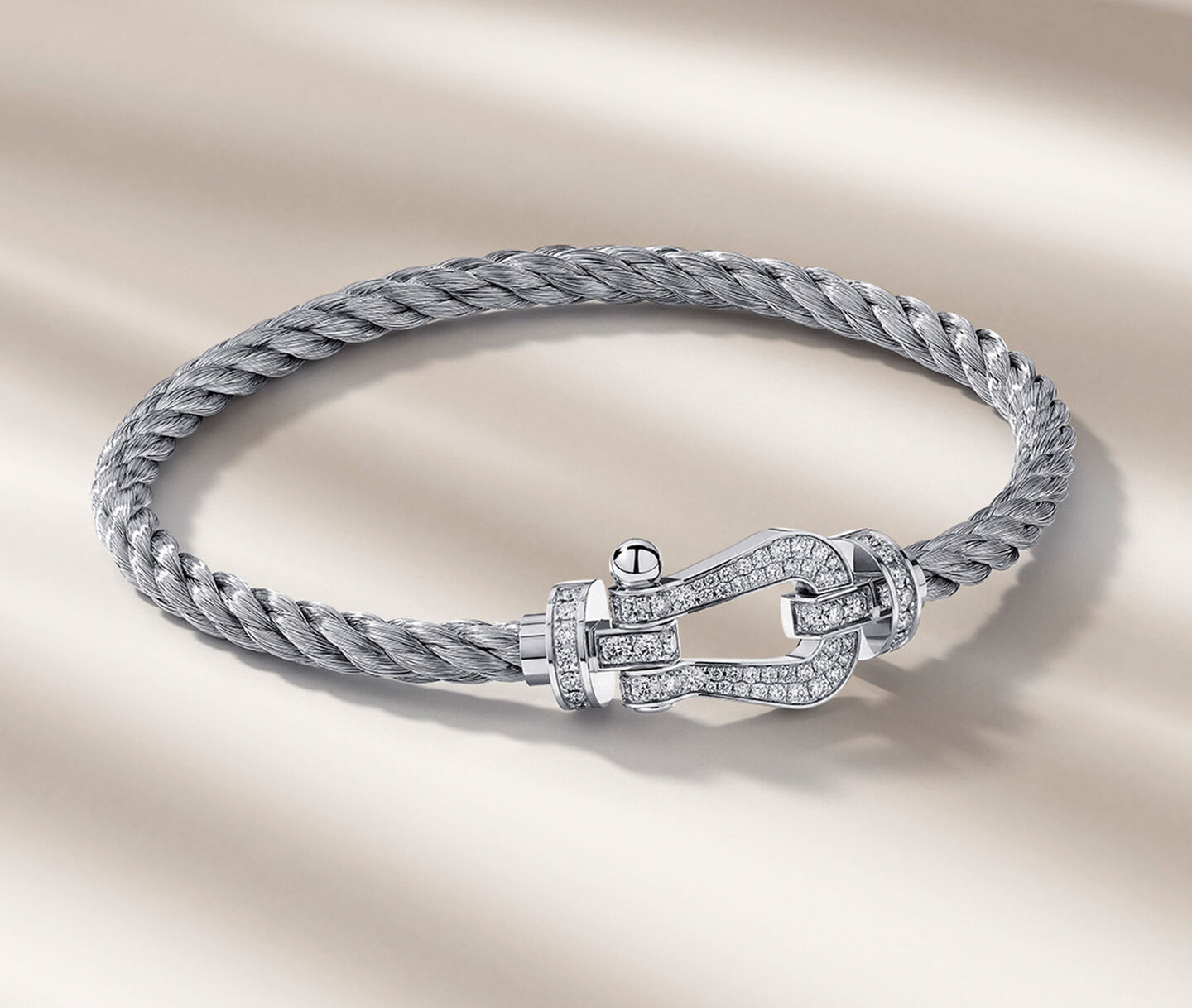 FRED Force 10 bracelet on a beige background.