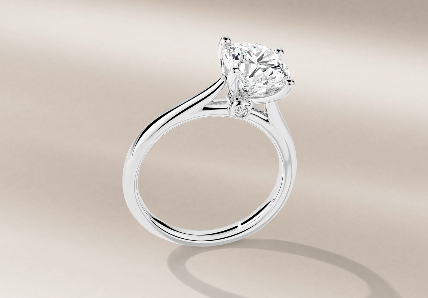 Birks 1879 diamond engagement ring on a beige background