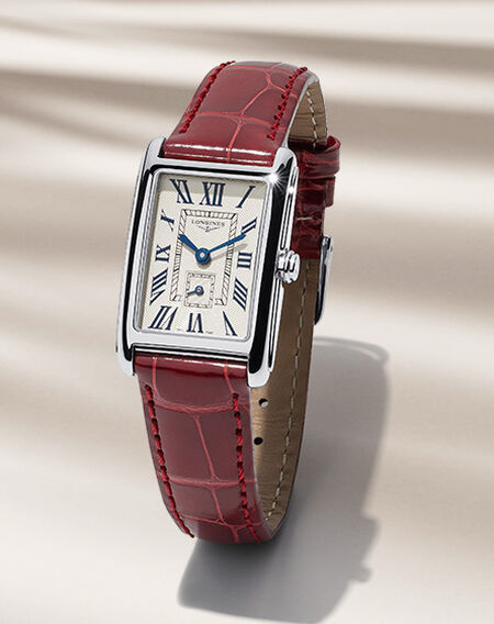 A Longines DolceVita women's watch on a beige background. 
